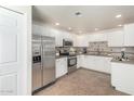 Well-lit kitchen showcasing stainless steel appliances, including a modern refrigerator, white cabinets, and stylish countertops at 9555 E Raintree Dr # 1018, Scottsdale, AZ 85260