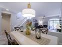 Dining area featuring stylish chandelier, table setting, and nearby stairway at 10017 E Mountain View Rd # 1087, Scottsdale, AZ 85258