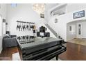 Bright living room with high ceilings, a grand piano, and a staircase with white railings at 11959 W Vernon Ave, Avondale, AZ 85392
