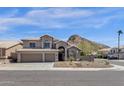 Inviting two-story home boasts desert landscaping, a three-car garage and mountain views at 14823 S 13Th Pl, Phoenix, AZ 85048