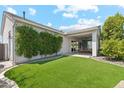 Expansive backyard with lush green lawn and a covered patio, ideal for outdoor entertaining and leisure at 17332 W Wildwood St, Surprise, AZ 85388