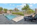 Backyard pool featuring a built-in spa and ample patio space perfect for relaxing or entertaining at 17332 W Wildwood St, Surprise, AZ 85388