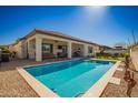 Inviting backyard pool and covered patio, perfect for outdoor relaxation and entertaining guests at 20916 E Arroyo Verde Dr, Queen Creek, AZ 85142
