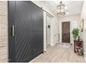 Elegant foyer showcasing a decorative barn door and stylish light fixture, enhancing the home's aesthetic at 20916 E Arroyo Verde Dr, Queen Creek, AZ 85142