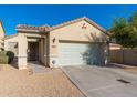 Charming single-story home featuring a two-car garage, low maintenance desert landscaping and a tile roof at 23005 N 19Th Way, Phoenix, AZ 85024