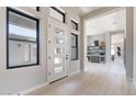 Bright entryway with a modern front door, sleek windows and hallway to a bar at 23656 N 123Rd St # 240, Scottsdale, AZ 85255