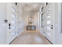 Elegant entryway featuring double doors, light wood floors, and stylish decor at 23656 N 123Rd St # 240, Scottsdale, AZ 85255