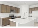 Bright kitchen featuring stainless steel appliances, a large island, and stylish cabinets at 23972 W Cocopah St, Buckeye, AZ 85326