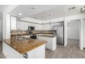 Well-lit kitchen featuring granite countertops, stainless steel appliances, and tile flooring at 26066 N 72Nd Ave, Peoria, AZ 85383