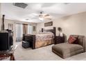 Comfortable bedroom with a ceiling fan, neutral walls, and an upholstered chaise lounge at 26066 N 72Nd Ave, Peoria, AZ 85383