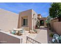 Charming courtyard featuring a patio table, seating area and vibrant desert plants and landscaping at 32835 N 70Th St, Scottsdale, AZ 85266