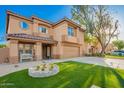 Two-story home showcasing an attractive facade, manicured lawn, and a welcoming covered porch at 3473 E Wyatt Way, Gilbert, AZ 85297