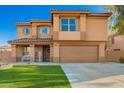 Two-story home showcasing an attractive facade, manicured lawn, and a welcoming covered porch at 3473 E Wyatt Way, Gilbert, AZ 85297