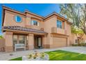 Two-story home showcasing an attractive facade, manicured lawn, and a welcoming covered porch at 3473 E Wyatt Way, Gilbert, AZ 85297
