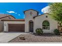 Beautiful single-story home showcasing an ornate entry door, desert landscaping, and a two-car garage at 3943 E Ficus Way, Gilbert, AZ 85298