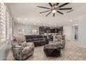 Open-concept living area with tile floors, ceiling fan and view of the kitchen at 3943 E Ficus Way, Gilbert, AZ 85298