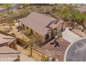 Beautiful property showcases a desert landscape, tile roof, and private backyard retreat at 4251 N Morning Dove Cir, Mesa, AZ 85207