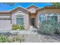 Inviting single-story home showcasing a tile roof, landscaped front yard, and attractive front entrance at 4306 W Summerside Rd, Laveen, AZ 85339
