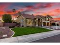 Charming two-story home boasts lush green lawn and beautifully landscaped yard at 4812 S Windstream Pl, Chandler, AZ 85249