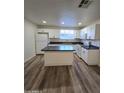 Updated kitchen features white cabinets, an island, and stainless steel appliances at 4924 W Catalina Dr, Phoenix, AZ 85031