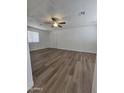 Bright living room featuring new hardwood flooring, ceiling fan, neutral paint, and plenty of natural light at 5201 N 61St Dr, Glendale, AZ 85301