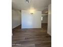 Inviting living room features new hardwood flooring, modern lighting, and neutral paint, ready for your personal touch at 5201 N 61St Dr, Glendale, AZ 85301
