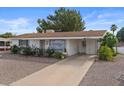 Attractive single-story home featuring a covered carport, desert landscaping, and a well-maintained exterior at 639 N 57Th Pl, Mesa, AZ 85205