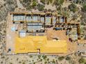 Aerial view of a new construction home featuring wood framing and partial roof under beautiful desert landscape at 7646 E Hidden Canyon St, Mesa, AZ 85207