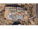 Aerial view of a home under construction, revealing its framing and layout amidst desert landscape at 7646 E Hidden Canyon St, Mesa, AZ 85207