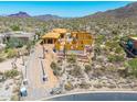 Exterior elevation of desert home under construction showcasing wood framing and mountain views at 7646 E Hidden Canyon St, Mesa, AZ 85207