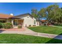 A picturesque home is complemented by a beautifully maintained lawn and carefully chosen desert landscaping at 8140 N 107Th Ave # 120, Peoria, AZ 85345
