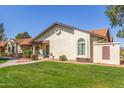 An inviting home shows off its manicured lawn, attractive landscape, and a cozy front porch at 8140 N 107Th Ave # 120, Peoria, AZ 85345