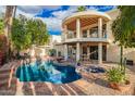Amazing backyard featuring a refreshing pool, hot tub, covered patio, and beautiful landscaping, great for entertaining at 8424 E San Bernardo Dr, Scottsdale, AZ 85258
