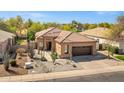 Attractive single-story home with a terracotta tile roof, desert landscaping, and a convenient attached garage at 903 W Raven Dr, Chandler, AZ 85286
