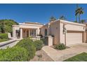 Charming single-story home featuring a two-car garage, desert landscaping, and secure gated entry at 10062 E Cinnabar Ave, Scottsdale, AZ 85258