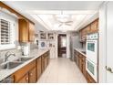 Well-lit kitchen with wood cabinets, modern appliances, and ample counter space at 10425 W Desert Forest Cir, Sun City, AZ 85351
