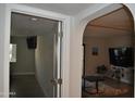 View of the living room from the doorway with gray and white color scheme and a large television at 10444 N 69Th St # 128, Paradise Valley, AZ 85253