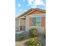 Detailed view of the home's charming exterior, showcasing the front entrance and wood shutters at 10961 W Taylor St, Avondale, AZ 85323