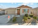 Charming single-story home with a well-manicured front yard, concrete driveway, and attached two-car garage at 10961 W Taylor St, Avondale, AZ 85323