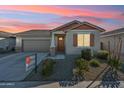 Charming single-story home with a well-manicured front yard, concrete driveway, and attached two-car garage at 10961 W Taylor St, Avondale, AZ 85323