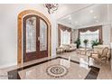 Elegant foyer showcases a decorative floor, chandelier, and a grand entryway to the living room at 11054 E North Ln, Scottsdale, AZ 85259