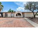 Charming one-story home featuring unique architectural details and desert-friendly landscaping at 1159 W Emelita Ave, Mesa, AZ 85210