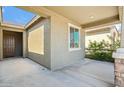 Covered porch featuring stone accents, tan stucco, and a brown front door at 11910 E Amanda Rd, Gold Canyon, AZ 85118