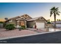 Lovely single-story home with a two-car garage, desert landscaping, and a palm tree at 15149 W Vale Dr, Goodyear, AZ 85395
