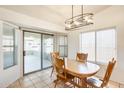 Inviting dining area with sliding doors to the enclosed porch offering ample natural light at 16034 W Carmen Dr, Surprise, AZ 85374