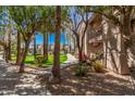 Beautifully landscaped grounds with mature trees and walkways leading to apartment buildings at 17017 N 12Th St # 2012, Phoenix, AZ 85022