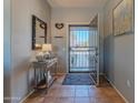 Inviting entryway featuring tile flooring, console table, and an open view to the outside at 19615 N Sunburst Way, Surprise, AZ 85374