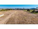 Vast, flat land awaiting development, bordered by greenery and hints of a nearby neighborhood at 20521 E Germann Rd, Queen Creek, AZ 85142