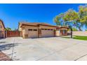 Driveway leading to a two car garage in front of home with manicured lawn at 20540 N 86Th Ln, Peoria, AZ 85382