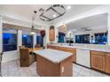 Well-lit kitchen with ample counter space, a kitchen island, and a dining area for casual meals at 20933 N 70Th Dr, Glendale, AZ 85308